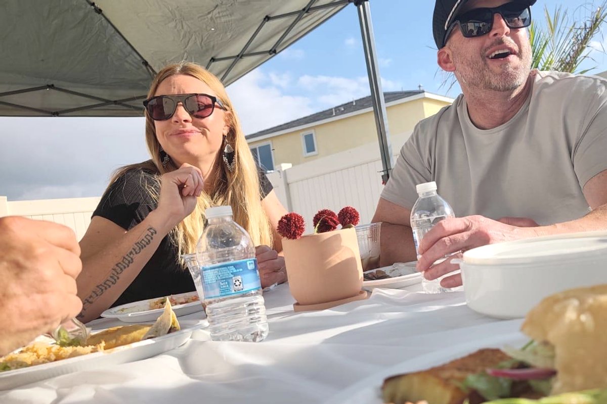 Andrew Boganwright sharing a meal and conversation with community