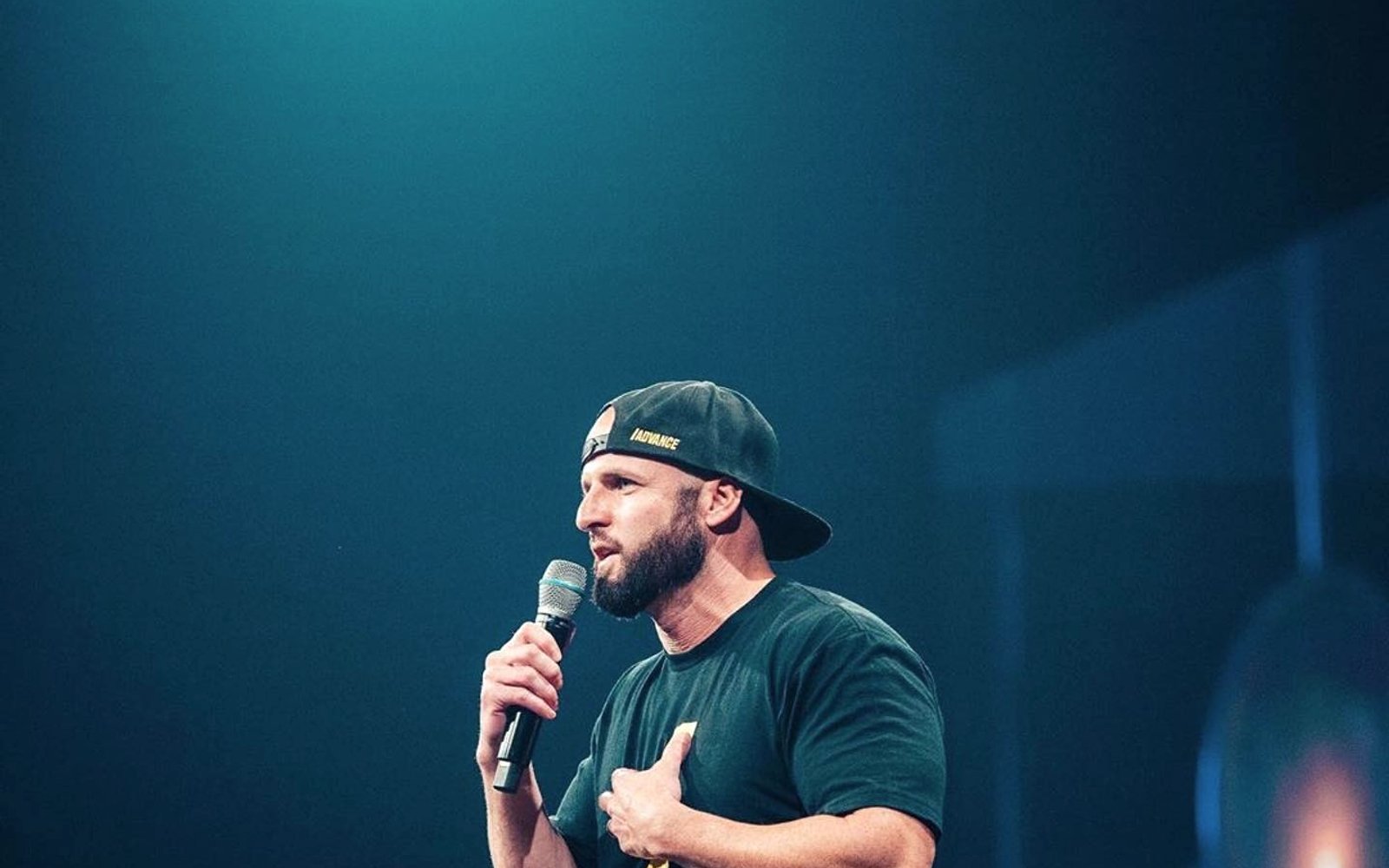 Andrew Boganwright speaking on stage about Christian leadership